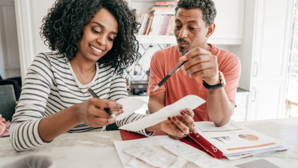 Two people sit and discuss tax benefits from a section 125 plan.